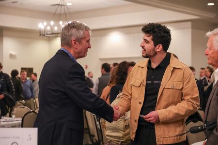 Alan Barnhart, president and CEO of Barnhart Crane and Rigging, talks with Micah Diaz, senior business major, after the Faith in the Marketplace luncheon. - Photo by Karley Hathcock