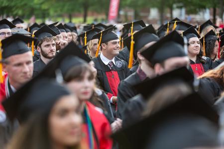 Ben Smith, biology major from Jackson, Tenn., smiles as he waits to receive his diploma during the spring graduation ceremony. - Photo by Karley Hathcock