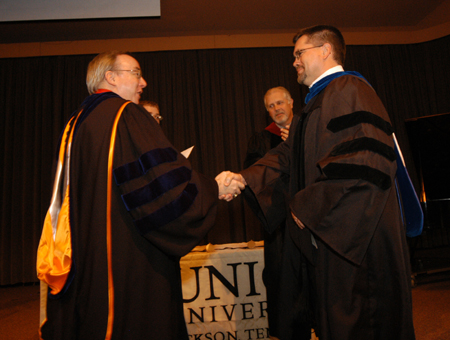 President Dockery congratulates mathematics professor Chris Hail after he was named Faculty of the Year during Awards Day. - Photo by Morris Abernathy