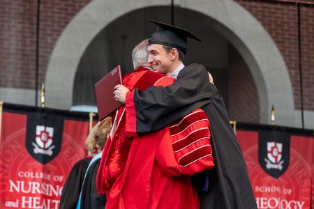Tanner Smith receives his bachelors of science in business administration from President Oliver at spring graduation. - Photo by Karley Hathcock