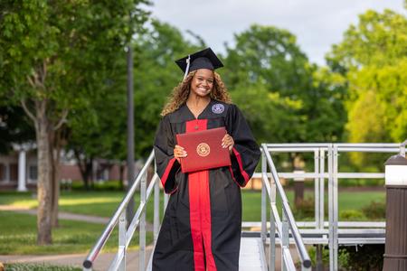 Hannah Hampel walks off stage after receiving her bachelor of arts in English at spring graduation. - Photo by Karley Hathcock