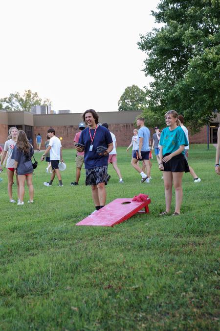 8/15/24 - A group of new students play a game of corn hole at the SAC fest during Welcome Week. - Karley Hathcock