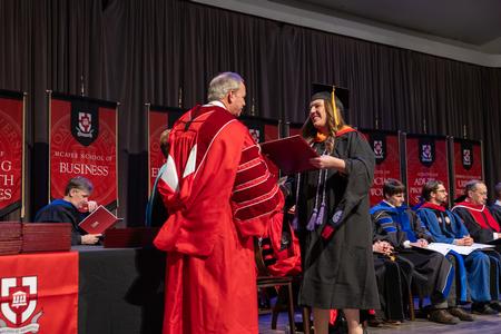 Rachel Mosely receives her Master of Science in Nursing degree from President Oliver during fall graduation. - Photo by Karley Hathcock