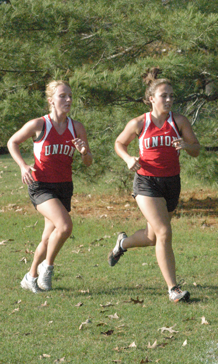 Ruth Schroeder (left) and Candace Cross (right) run inthe 2004 TranSouth Conference Cross Country Meet.  Union took first place with Cross being named the Freshman Runner of the Year. - Photo by Steven Aldridge