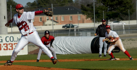 Charlie Ligon (27) pitches as Josh Allen (11) holds the runner at first base. - Photo by Kathleen Murray