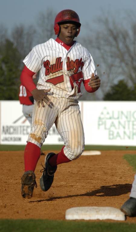 Patrick Williams (23) attempts to take third base in a game versus William Carey College. - Photo by Kathleen Murray