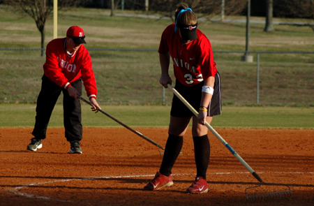 Head Coach Brian Dunn and pitcher Chrissa Norton take care of field preparation prior to one of Union's home games at Fesmire Field. - Photo by Amanda Herron