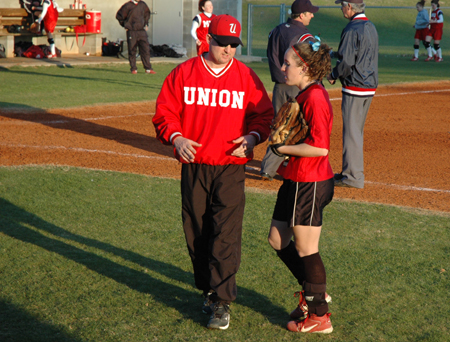 Head Coach Brian Dunn talks strategy with senior outfielder Allison Shein. - Photo by Amanda Herron