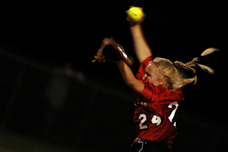 Mary Kosco (24) starts her windup just before making a pitch. - Photo by Jonathan Blair