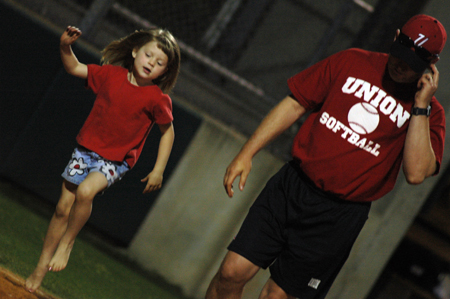 Union head coach Brian Dunn leaves the field with youngest daughter Ashley following a Union game. - Photo by Jonathan Blair