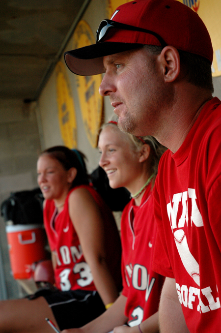 Union Chrissa Norton (33), Mary Kosco (24), and head coach Brian Dunn enjoy the action on the field as they look on from the dugout. - Photo by Jonathan Blair