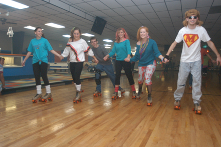A group of 80s-clad students forms a skating chain during the 80s Skate Night. - Photo by Jonathan Blair