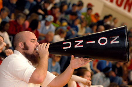Sophomore cheerleader Jared Swinney brings out the big guns during a men’s basketball game. - Photo by Jonathan Blair