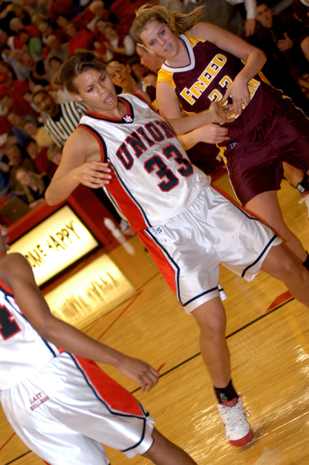 Stephanie Clark fights for position as she post up against Freed-Hardeman's defense. - Photo by Jonathan Blair