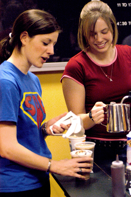 Union Alum Ashley Murphy prepares a coffee drink for Sophomore Lindsey Abell at Union's Homecoming Coffeehouse featuring Andrew Peterson. - Photo by Jonathan Blair