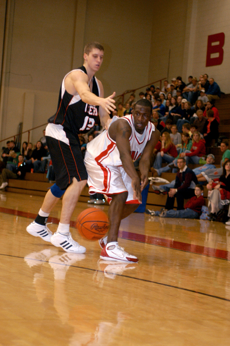 Junior Corey Burkett makes a bounce pass as he is defended closely during the Bulldog's victory against Georgetown. - Photo by Kristen Nicole Sayres