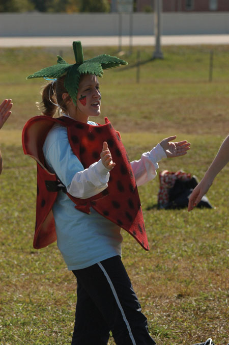 Dawning her strawberry costume, senior Courtney David cheers her Zeta teammates on at the Greek Olympics. - Photo by Kristen Hiller