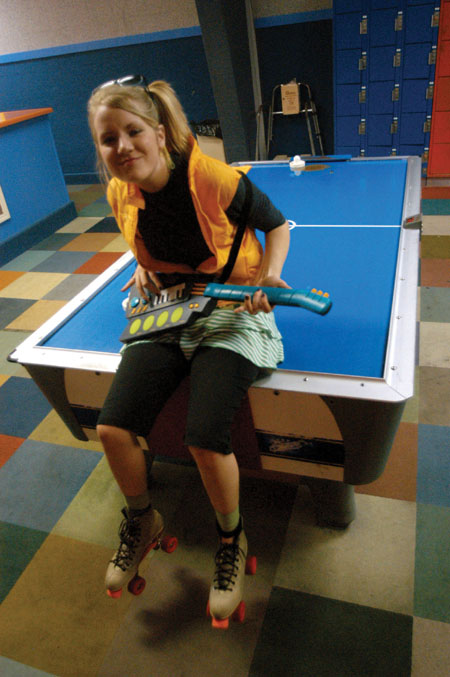 Freshman Debra Howell rocks a tune out on her 80s throwback toy electric guitar at the SAC sponsered 80s Skate Night. - Photo by Jonathan Blair