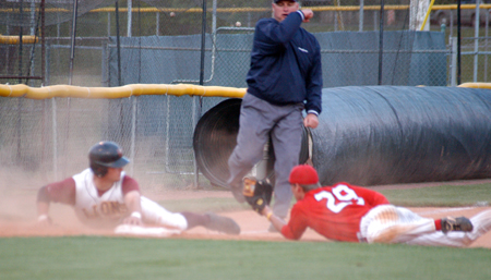 Senior Seth Silcock shows the tag as the third-base umpire calls the runner out during a game versus Freed-Hardeman in the TranSouth Conference Tournament.  Union won the game to advance to the semifinals. - Photo by Steven Aldridge