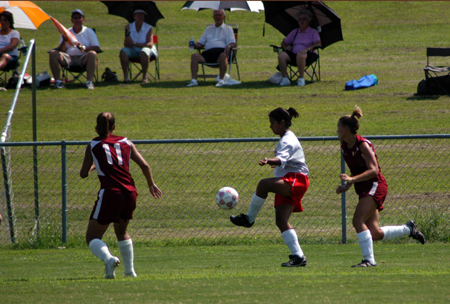 Cynthia Medina displays some ball handling skills as two defenders look on.
 - Photo by Morris Abernathy