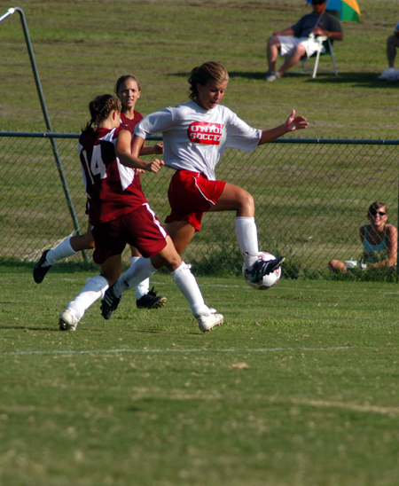 Freshman Emily Rawls blocks a defender as she advances the ball towards the center of the field. - Photo by Morris Abernathy