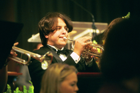 Junior Brent Cone plays his trumpet in the Symphonic Band during the Chuck Colson chapel service. - Photo by Jim Veneman