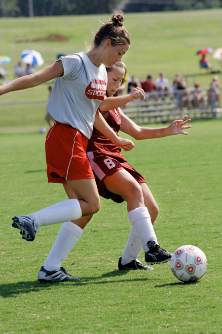 Charity Carter, sophomore, fights for the ball with a Freed-Hardeman player. - Photo by Kyle Kurlick
