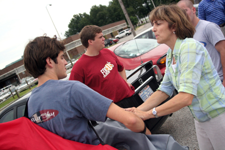 Jonathan Waite says a few goodbyes to his mother as he and Clayton Sanderson finish unloading his car on Freshman Move-In Day. - Photo by Kyle Kurlick