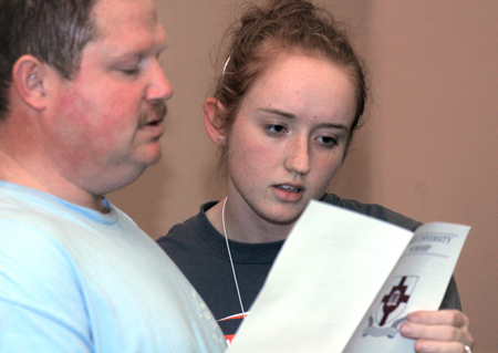 Gary Stephens and Alyssa Jones look over their program during the New Student Orientation Chapel. - Photo by Kyle Kurlick