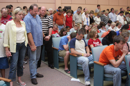 Parents surround their children in prayer at the worship service held on the first day of New Student Orientation.  - Photo by Kyle Kurlick