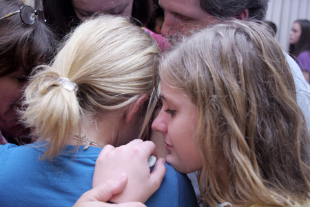 Nicole Hamilton, sister of Ashley Hamilton, prays with her family for her sister after the New Student Orientation Chapel. - Photo by Kyle Kurlick