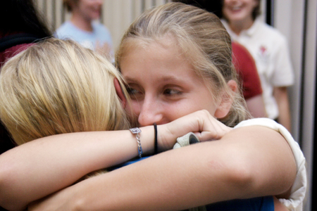 Brittany Hamilton (right) hugs her freshman sister Ashley Hamilton after the fall orientation chapel service. - Photo by Kyle Kurlick