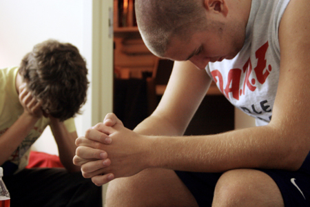Freshmen Matt Elia of Bartlett, Tenn. and Parker Shipp of Murfreesboro, Tenn. pray during a Bible study with their resident assistant during New Student Orientation. - Photo by Kyle Kurlick