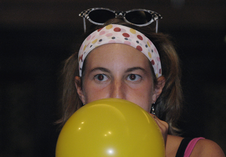 Sophomore Kasey Cobb inflates a balloon for the SAC Game Show. - Photo by Kathleen Murray