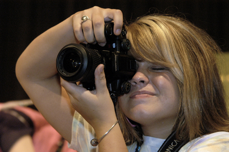 Sophomore Sally Goulooze captures the action at the SAC Game Show during New Student Orientation. - Photo by Kathleen Murray
