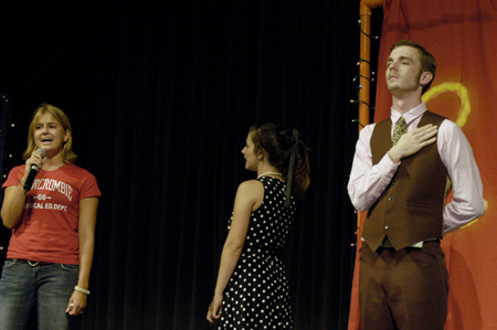 Sophomore Carson Turner leads a pledge for fun with Junior Lindsey Abell and Lyndsey Sparks at the SAC Game Show during New Student Orientation. - Photo by Kathleen Murray