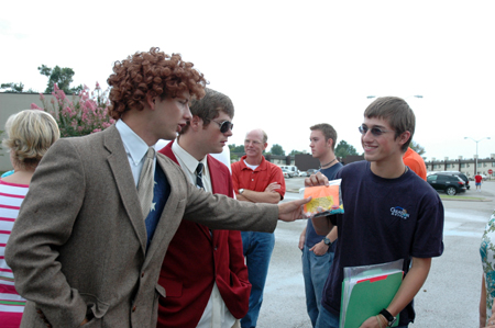 Daniel Holsinger and Scott Griffin hand out goody bags to freshmen while making a LIFE Group video during Freshman move-in day. - Photo by Kristen Nicole Sayres