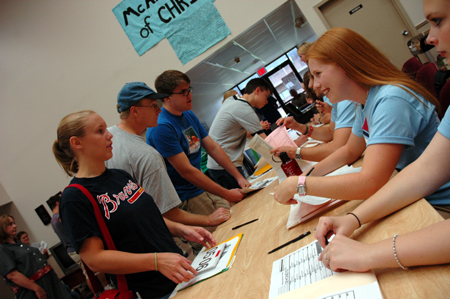 Residence Assistants check new students into the McAfee complex during Freshmen Move-In Day.  - Photo by Kristen Nicole Sayres