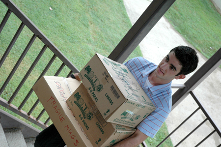 A new student of Jonesborough, Tenn. carries a load of belongings to his room during Freshman Move-In Day. - Photo by Kristen Nicole Sayres