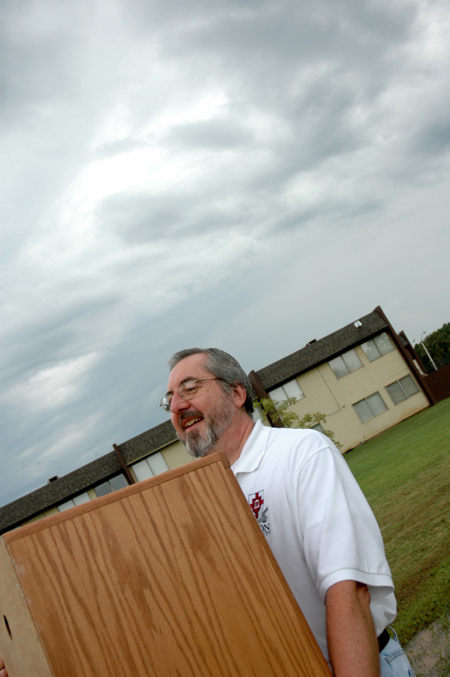 Sam Myatt, director of academic services for continuing studies, helps new students move in under some menacing clouds on Freshman Move-In Day. - Photo by Kristen Nicole Sayres