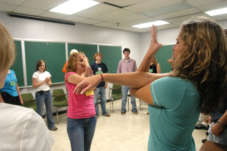 Junior Focus leader Rachel Melton demonstrates a game to Freshman Jenna Cherry of Friendship, Tenn. during New Student Orientation. - Photo by Brad Moore