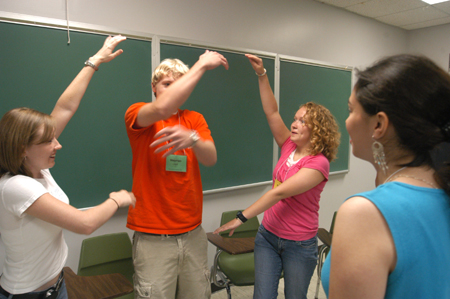 Freshmen Morgan Channell, Stephen Carroll, and Katie Chin play a bonding game with their Focus leader Rachel Melton (center right) during New Student Orientation.  - Photo by Brad Moore