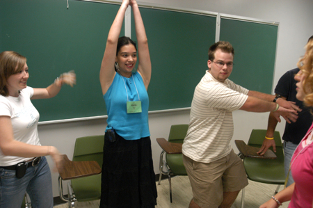 New Students Morgan Channell, Katie Chin, Joshua Armacost demonstrate their technique to their Focus leader Rachel Melton during New Student Orientation. - Photo by Brad Moore