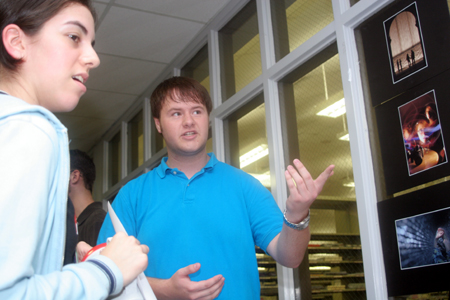 Senior Brad Moore describes the Union Association of Photographers to Freshman Stephanny Rodriquez during the Student Life Fair. - Photo by Kyle Kurlick