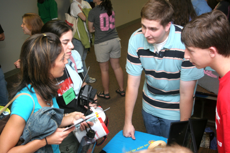 Tyler Whetstone (center) & Cam Armstrong (right) enlightens Kristmar Rawlins & Stephanny Rodriquez about GO Trips at the Student Life Fair during New Student Orientation. - Photo by Kyle Kurlick