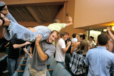 Senior Tony Winkler helps Senior Joel Polk get a higher perspective for welcoming freshmen to the Focus Show. - Photo by Brad Moore