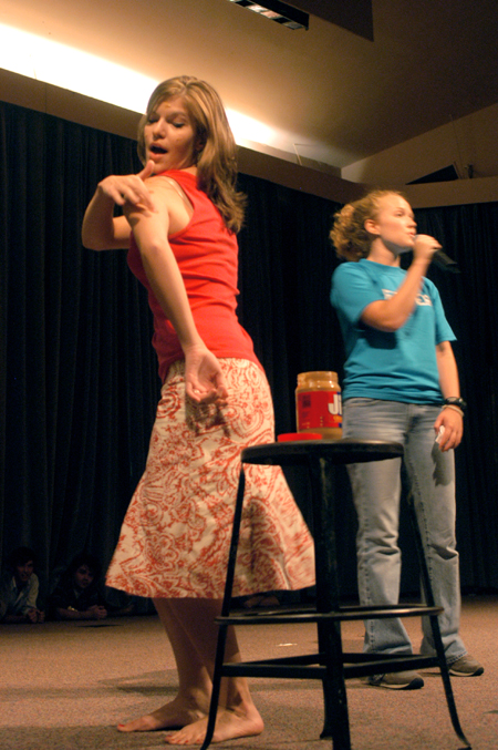 Junior Elisabeth Berry demonstrates the versatility of peanut butter as senior Rachel Melton describes its uses to the audience at the Focus Show. - Photo by Brad Moore