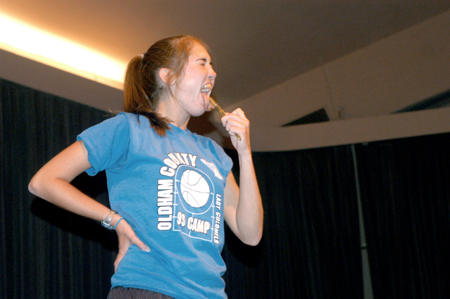 Sophomore Corrie Rose brushes her tongue with a community toothbrush in a skit for the Focus Show. - Photo by Brad Moore