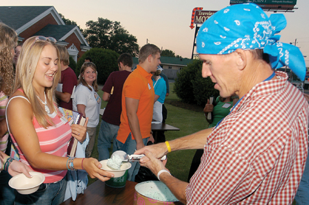 Senior Katie Dratnol, special education major, gets a
scoop of ice cream from cross-country coach Gary Johnson after Englewood Baptist Church's first "Refuge" service on Aug. 31. Churches minister to students during the first weeks of school in unique ways. - Photo by Brad Moore