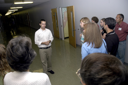 Sophomore Brent Parrish leads a group of prospective students and their families down the C-Hallway on a Preview Day. - Photo by Kathleen Murray